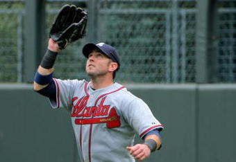 DENVER - JULY 12:  Ryan Church #25 of the Atlanta Braves fields a fly ball as he plays defense against the Colorado Rockies during MLB action at Coors Field on July 12, 2009 in Denver, Colorado. The Rockies defeated the Braves 8-7.  (Photo by Doug Pensinger/Getty Images)