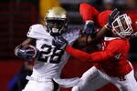 PISCATAWAY, NJ - OCTOBER 16: Dion Lewis #28 of the University of Pittsburgh Panthers stiff arms David Rowe #4 of the Rutgers University Scarlett Knights on October 16, 2009 at Rutgers Stadium in Piscataway, New Jersey. (Photo by Jared Wickerham/Getty Images)