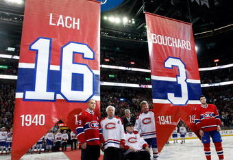 MONTREAL- DECEMBER 4:  Former Montreal Canadiens Elmer Lach and Emile Bouchard are honored by having their numbers retired during the Centennial Celebration ceremonies prior to the NHL game between the Montreal Canadiens and Boston Bruins on December 4, 2009 at the Bell Centre in Montreal, Quebec, Canada.  (Photo by Richard Wolowicz/Getty Images)