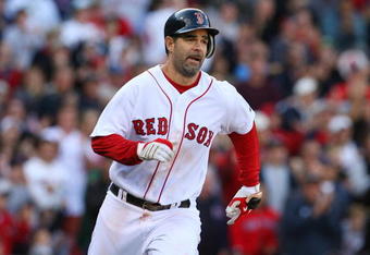 BOSTON - OCTOBER 11:  Mike Lowell #25 of the Boston Red Sox runs to first after he hits a RBI single in the eighth inning against the Los Angeles Angels of Anaheim in Game Three of the ALDS during the 2009 MLB Playoffs at Fenway Park on October 11, 2009 in Boston,  Massachusetts. (Photo by Jim Rogash/Getty Images)
