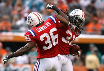 MIAMI - DECEMBER 06:  Safety Brandon Meriweather #31 of the New England Patriots celebrates with safety James Sanders #36 after Meriweather's interception of quarterback Chad Henne #7 of the Miami Dolphins at Land Shark Stadium on December 6, 2009 in Miami, Florida.  (Photo by Doug Benc/Getty Images)