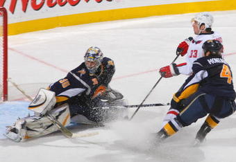 BUFFALO, NY - DECEMBER 09: Ryan Miller #30 and Steve Montador #4 of the Buffalo Sabres defend on Alexander Giroux #33 of the Washington Capitals at HSBC Arena on December 9, 2009 in Buffalo, New York.  (Photo by Rick Stewart/Getty Images)