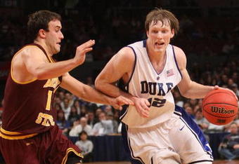 NEW YORK - NOVEMBER 25:  Kyle Singler #12 of the Duke Blue Devils drives to the basket against Derek Glasser #12 of the Arizona State Sun Devils at Madison Square Garden on November 25, 2009 in New York, New York.  (Photo by Nick Laham/Getty Images)