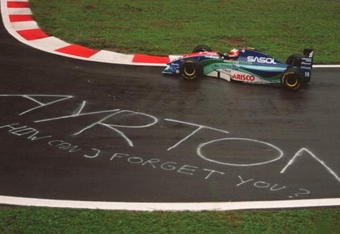 28 AUG 1994:  RUBENS BARRICHELLO OF BRAZIL PASSES THE TRIBUTE TO FORMER WORLD CHAMPION AYRTON SENNA WRITTEN ON THE TARMAC DURING TODAYS QUALIFYING SESSION FOR THE FORMULA ONE BELGIAN GRAND PRIX IN SPA, BELGIUM.  Mandatory Credit: Mike Cooper/ALLSPORT