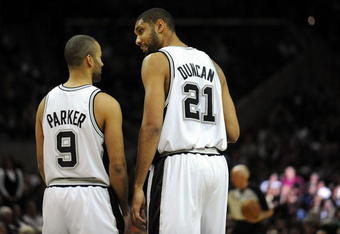 SAN ANTONIO - DECEMBER 03:  Tony Parker #9 and Tim Duncan #21 of the San Antonio Spurs before a game against the Boston Celtics on December 3, 2009 at AT&T Center in San Antonio, Texas.  NOTE TO USER: User expressly acknowledges and agrees that, by downloading and/or using this Photograph, user is consenting to the terms and conditions of the Getty Images License Agreement.  (Photo by Ronald Martinez/Getty Images)