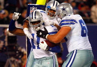 EAST RUTHERFORD, NJ - DECEMBER 06:  (L-R) Roy Williams #11, Marion Barber #24 and Doug Free #68 of the Dallas Cowboys celebrate after Williams scored a 5-yard touchdown reception in the third quarter against the New York Giants at Giants Stadium on December 6, 2009 in East Rutherford, New Jersey.  (Photo by Chris Chambers/Getty Images)