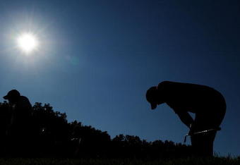 CHASKA, MN - AUGUST 16:  Tiger Woods (R) reacts to his tee shot on the 17th hole as caddie Steve Williams walks off during the final round of the 91st PGA Championship at Hazeltine National Golf Club on August 16, 2009 in Chaska, Minnesota.  (Photo by Stuart Franklin/Getty Images)