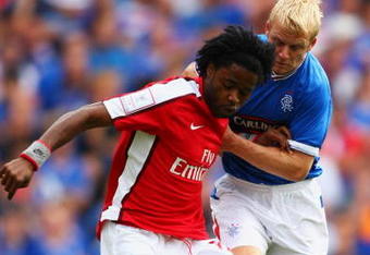 LONDON, ENGLAND - AUGUST 02:  Alex Song of Arsenal holds off the challenge from Steven Naismith of Rangers during the Emirates Cup match between Arsenal and Glasgow Rangers at the Emirates Stadium on August 2, 2009 in London, England.  (Photo by Phil Cole/Getty Images)