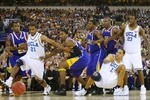 INDIANAPOLIS - APRIL 1:  Cedric Bozeman #21 of the UCLA Bruins fends off the LSU Tigers defense for posession of the ball during the semifinal game of the NCAA Men's Final Four on April 1, 2006 at the RCA Dome in Indianapolis, Indiana. (Photo by Andy Lyons/Getty Images) 