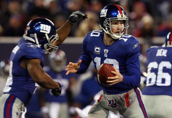 EAST RUTHERFORD, NJ - DECEMBER 06:  Eli Manning #10 of the New York Giants looks to throw a pass against the Dallas Cowboys on December 6, 2009 at Giants Stadium in East Rutherford, New Jersey. The Giants defeated the Cowboys 31-24.  (Photo by Jim McIsaac/Getty Images)