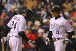 DENVER - OCTOBER 11:  Carlos Gonzalez #5 of the Colorado Rockies celebrates with teammate Dexter Fowler #24 after hitting a game tying home run against the Philadelphia Phillies in the bottom of the fourth inning in Game Three of the NLDS during the 2009 MLB Playoffs at Coors Field on October 11, 2009 in Denver, Colorado.  (Photo by Doug Pensinger/ Getty Images)