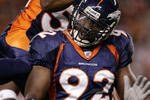 DENVER - OCTOBER 15:  Defensive End Elvis Dumervil #92 of the Denver Broncos celebrates a sack on quarterback Andrew Walter of the Oakland Raiders with linebacker Ian Gold #52 in the first quarter on October 15, 2006 at Invesco Field at Mile High in Denver, Colorado.  The Broncos lead 10-0 in the second quarter.  (Photo by Brian Bahr/Getty Images)