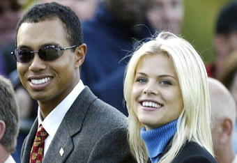 SUTTON COLDFIELD - SEPTEMBER 26:  Golfer Tiger Woods poses with girlfriend Elin Nordegren during the opening Ceremony for the 34th Ryder Cup on September 26, 2002 in Sutton Coldfield, England. (Photo by Andrew Redington/Getty Images)