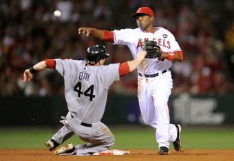 ANAHEIM, CA - OCTOBER 08:  Howie Kendrick #47 of the Los Angeles Angels of Anaheim turns a double play on Jason Bay  #44 at of the Boston Red Sox at second the throws to first base to get Mike Lowell #25 in Game One of the ALDS during the 2009 MLB Playoffs at Angel Stadium on October 8, 2009 in Anaheim, California.  (Photo by Kevork Djansezian/Getty Images)