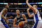 LOS ANGELES, CA - DECEMBER 13:  Manu Ginobili #20 of the San Antonio Spurs splits the defense of Chris Kaman #35 and Marcus Camby #23 of the Los Angeles Clippers during the game at Staples Center on December 13, 2009 in Los Angeles, California. The Spurs won 115-90.  NOTE TO USER: User expressly acknowledges and agrees that, by downloading and/or using this Photograph, user is consenting to the terms and conditions of the Getty Images License Agreement.  (Photo by Harry How/Getty Images)