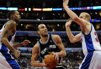 LOS ANGELES, CA - DECEMBER 13:  Manu Ginobili #20 of the San Antonio Spurs splits the defense of Chris Kaman #35 and Marcus Camby #23 of the Los Angeles Clippers during the game at Staples Center on December 13, 2009 in Los Angeles, California. The Spurs won 115-90.  NOTE TO USER: User expressly acknowledges and agrees that, by downloading and/or using this Photograph, user is consenting to the terms and conditions of the Getty Images License Agreement.  (Photo by Harry How/Getty Images)
