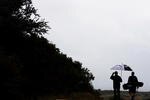 SYDNEY, AUSTRALIA - DECEMBER 01:  Golfers make their way back to the clubhouse after rain sets in during a practice round ahead of the Australian Open Golf Championship at New South Wales Golf Club, La Perouse on December 1, 2009 in Sydney, Australia.  (Photo by Craig Golding/Getty Images)