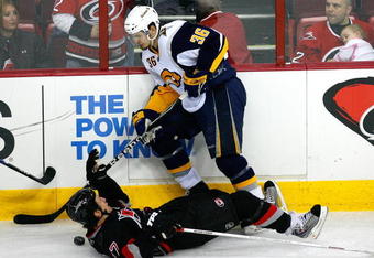 RALEIGH, NC - FEBRUARY 26:  Rod Brind'Amour #17 of the Carolina Hurricanes is knocked to the ice after being hit by Patrick Kaleta #36 of the Buffalo Sabres during the game on February 26, 2009 at RBC Center in Raleigh, North Carolina.  (Photo by Kevin C. Cox/Getty Images)