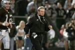 5 Nov 2001:   Jon Gruden head coach of the Oakland Raiders runs onto the field with quarterback Rich Gannon for the second half of their game versus the Denver Broncos at Network Associates Coliseum in Oakland, California.  The Raiders won 38-28.  DIGITAL IMAGE   Mandatory Credit:   Jed Jacobsohn/Allsport