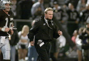 5 Nov 2001:   Jon Gruden head coach of the Oakland Raiders runs onto the field with quarterback Rich Gannon for the second half of their game versus the Denver Broncos at Network Associates Coliseum in Oakland, California.  The Raiders won 38-28.  DIGITAL IMAGE   Mandatory Credit:   Jed Jacobsohn/Allsport