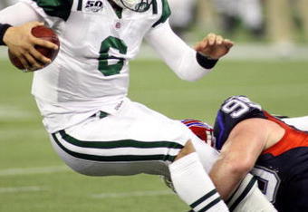 TORONTO - DECEMBER 3:  Kyle Williams #95 of the Buffalo Bills tackles quarterback Mark Sanchez #6 of the New York Jets during their NFL game on December 3, 2009  at Rogers Centre in Toronto, Ontario, Canada. The Jets defeated the Bills 19-13. (Photo by Rick Stewart/Getty Images)