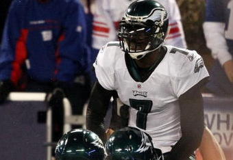 EAST RUTHERFORD, NJ - DECEMBER 13:  Michael Vick #7 of the Philadelphia Eagles celebrates after scoring a touchdown in the second quater with Todd Herremans #79 and Nick Cole #59 against the New York Giants at Giants Stadium on December 13, 2009 in East Rutherford, New Jersey.  (Photo by Nick Laham/Getty Images)