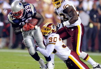 LANDOVER, MD - AUGUST 28:  LaRon Landry #30 of the Washington Redskins tackles Laurence Maroney #39 of the New England Patriots during a preseason game at FedExField on August 28, 2009 in Landover, Maryland.  (Photo by Greg Fiume/Getty Images)