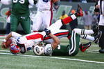 EAST RUTHERFORD, NJ - DECEMBER 14:  JP Losman #7 of The Buffalo Bills scores a touchdown in the first quarter as Eric Smith #33 of the New York Jets makes the tackle on December 14, 2008 at Giants Stadium in East Rutherford, New Jersey.  (Photo by Al Bello/Getty Images)