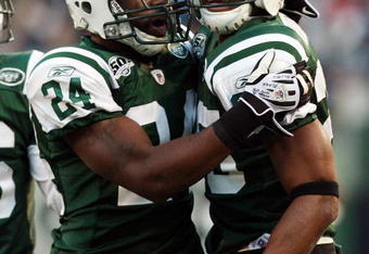 EAST RUTHERFORD, NJ - NOVEMBER 29:  Kerry Rhodes #25 of the New York Jets celebrates his second interception of the game against the Carolina Panthers with teammate Darrelle Revis #24 on November 29, 2009 at Giants Stadium in East Rutherford, New Jersey. The Jets defeated the Panthers 17-6.  (Photo by Jim McIsaac/Getty Images)