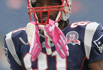FOXBORO, MA - OCTOBER 4:  Randy Moss #81 of the New England Patriots  adjust his pink gloves, worn to support Breast Cancer Awareness, before a game with the Baltimore Ravens at Gillette Stadium on October 4, 2009 in Foxboro, Massachusetts. (Photo by Jim Rogash/Getty Images)