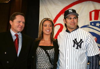 BRONX, NY - DECEMBER 23:  Johnny Damon (right) #18 of the New York Yankees poses for a portrait with his wife Michelle and his agent Scott Boras, during a press conference to announce that Damon is Yankees' new center fielder on December 23, 2005 at Yankee Stadium in the Bronx borough of New York City, New York.  (Photo by Al Bello/Getty Images)