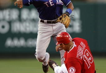 ANAHEIM, CA - JULY 8:  Shortstop Elvis Andrus #1 of the Texas Rangers throws to first base to complete a double play after forcing out Kendry Morales #19 of the Los Angeles Angels of Anaheim at Angel Stadium July 8, 2009 in Anaheim, California.  (Photo by Stephen Dunn/Getty Images)