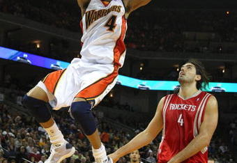 OAKLAND, CA - DECEMBER 12:  Anthony Randolph #4 of the Golden State Warriors shoots over Luis Scola #4 of the Houston Rockets during an NBA game on December 12, 2008 at Oracle Arena in Oakland, California. NOTE TO USER: User expressly acknowledges and agrees that, by downloading and or using this photograph, User is consenting to the terms and conditions of the Getty Images License Agreement.  (Photo by Jed Jacobsohn/Getty Images)