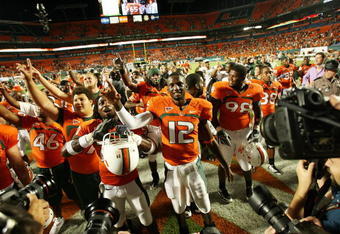 FORT LAUDERDALE, FL - OCTOBER 03: Quarterback Jacory Harris #12 of the Miami Hurricanes celebrates with teammates after a victory over the Oklahoma Sooners at Land Shark Stadium on October 3, 2009 in Fort Lauderdale, Florida. Miami defeated Oklahoma 21-20. (Photo by Doug Benc/Getty Images)