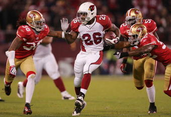 SAN FRANCISCO - DECEMBER 14:  Running back Beanie Wells #26 of the Arizona Cardinals rushes past safeties Michael Lewis #32 and Dashon Goldson #38 of the San Francisco 49ers at Candlestick Park on December 14, 2009 in San Francisco, California. (Photo by Ezra Shaw/Getty Images)