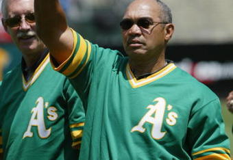 OAKLAND, CA - AUGUST 2:  Baseball hall of famer Reggie Jackson of the 1973 World Champion Oakland Athletics waves to the crowd during a ceremony before the game against the New York Yankees at the Network Associates Coliseum on August 2, 2003 in Oakland, California. The Yankees defeated the Athletics 10-7. (Photo by Justin Sullivan/Getty Images)
