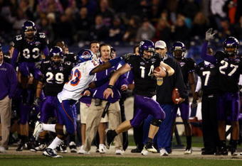 SAN DIEGO, CA - DECEMBER 23:  Quarterback Andy Dalton #14 of  TCU runs with the ball against the tackle of Safety Jeron Johnson #23 of Boise State during the San Diego County Credit Union Poinsettia Bowl at Qualcomm Stadium on December 23, 2008 in San Diego, California. (Photo by Donald Miralle/Getty Images)