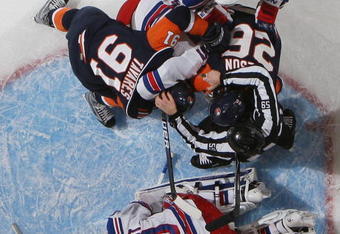 UNIONDALE, NY - DECEMBER 17: Henrik Lundqvist #30 of the New York Rangers defends the net against John Tavares #91 and Matt Moulson #26 of the New York Islanders at the Nassau Coliseum on December 17, 2009 in Uniondale, New York. The Rangers defeated the Islanders 5-2. (Photo by Bruce Bennett/Getty Images)