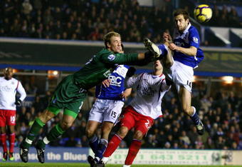 BIRMINGHAM, ENGLAND - DECEMBER 15:  Goalkeeper Joe Hart of Birmingham colides with his own defender Roger Johnson as he clears a cross during the Barclays Premier League match between Birmingham City and Blackburn Rovers at St. Andrews on December 15, 2009 in Birmingham, England.  (Photo by Richard Heathcote/Getty Images)