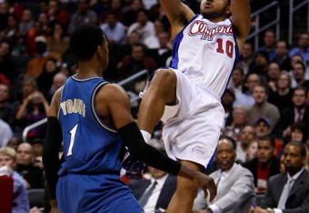 LOS ANGELES, CA - DECEMBER 14:  Eric Gordon #10 of the Los Angeles Clippers shoots over Nick Young #1 of the Washington Wizards in the second half at Staples Center on December 14, 2009 in Los Angeles, California. The Clippers defeated the Wizards 97-95. NOTE TO USER: User expressly acknowledges and agrees that, by downloading and/or using this Photograph, user is consenting to the terms and conditions of the Getty Images License Agreement.  (Photo by Jeff Gross/Getty Images)