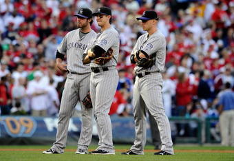 PHILADELPHIA - OCTOBER 08:  (L-R) Ian Stewart #9, Troy Tulowitzki #2 and Clint Barmes #12 of the Colorado Rockies look on during a pitching change against the Philadelphia Phillies in Game Two of the NLDS during the 2009 MLB Playoffs at Citizens Bank Park on October 8, 2009 in Philadelphia, Pennsylvania. The Rockies won 5-4.  (Photo by Jeff Zelevansky/Getty Images)