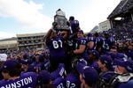 FORT WORTH, TX - NOVEMBER 28:  Marcus Cannon #61, Kyle Dooley #72 and Alonzo Adams #81 of the TCU Horned Frogs raise the Mountain West Regular Season Championship trophy at Amon G. Carter Stadium on November 28, 2009 in Fort Worth, Texas.  (Photo by Ronald Martinez/Getty Images)