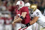 PALO ALTO, CA - NOVEMBER 28:  Toby Gerhart #7 of the Stanford Cardinal is tackled by Manti Te'o #5 of the Notre Dame Fighting Irish at Stanford Stadium on November 28, 2009 in Palo Alto, California.  (Photo by Ezra Shaw/Getty Images)