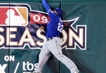 ANAHEIM, CA - SEPTEMBER 28: Marlon Byrd #22 of the Texas Rangers crashes against  the center field in an attempt to catch the two-run home run Kendry Morales #19  Los Angeles Angels of Anaheim during first inning of the baseball game at Angel Stadium on September 28, 2009 in Anaheim, California.  (Photo by Kevork Djansezian/Getty Images)