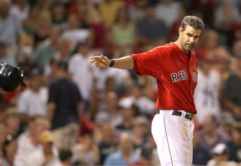 BOSTON - AUGUST 21:  Mike Lowell #25 of the Boston Red Sox  reacts in the seventh after striking out against the New York Yankees at Fenway Park on August 21, 2009 in Boston, Massachusetts. (Photo by Jim Rogash/Getty Images)