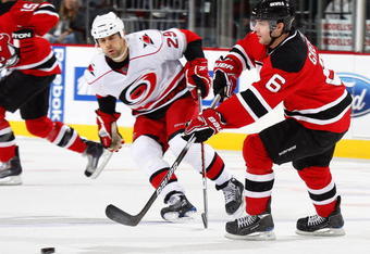 NEWARK, NJ - DECEMBER 09:  Andy Greene #6 of the New Jersey Devils clears the puck against the Carolina Hurricanes on December 9, 2009 in Newark, New Jersey.  (Photo by Paul Bereswill/Getty Images)