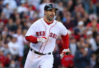 BOSTON - OCTOBER 11:  Mike Lowell #25 of the Boston Red Sox runs to first after he hits a RBI single in the eighth inning against the Los Angeles Angels of Anaheim in Game Three of the ALDS during the 2009 MLB Playoffs at Fenway Park on October 11, 2009 in Boston,  Massachusetts. (Photo by Jim Rogash/Getty Images)