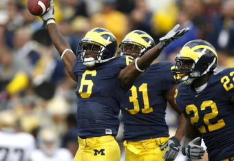 ANN ARBOR, MI - SEPTEMBER 15:  Donovan Warren #6 of the Michigan Wolverines celebrates a first quarter fumble recovery with Jamar Adams #22 and Brandent Englemon #31 during a game against the Notre Dame Fighting Irish at Michigan Stadium September 15, 2007 in Ann Arbor, Michigan.  (Photo by Gregory Shamus/Getty Images)
