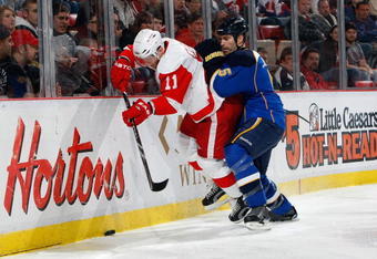 DETROIT - DECEMBER 9:  Dan Cleary #11 of the Detroit Red Wings battles for the puck against Barret Jackman #5 of the St. Louis Blues during the game at Joe Louis Arena on December 9, 2009 in Detroit, Michigan. (Photo by Dave Sandford/Getty Images)