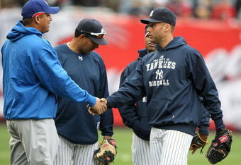 NEW YORK - APRIL 04:  Derek Jeter #2 of the New York Yankees shakes hands with Carlos Zambrano #38 of the Chicago Cubs during batting practice on April 4, 2009 at Yankee Stadium in the Bronx borough of New York City.  (Photo by Nick Laham/Getty Images)